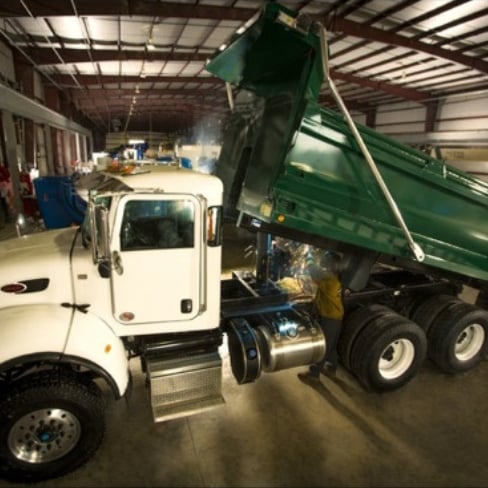 Truck with green dump body