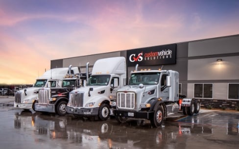 Trucks lined up outside Custom Vehicle Solutions building